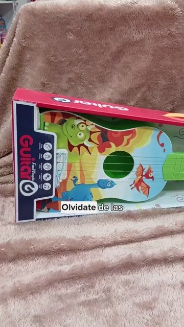Video de Guitarra Infantil Dinosaurio Fantasía Cuerdas Metálicas 55Cm